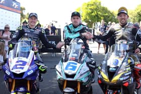 Michael Dunlop celebrates his victory in the first Monster Energy Supersport race at the Isle of Man TT with runner-up Peter Hickman (right) and Dean Harrison