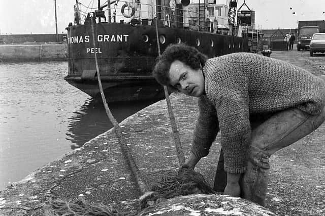 Pictured in April 1981 is acting master Derek Brown who is seen checking the mooring ropes the coaster Thomas Grant – Northern Ireland’s trading link with the Isle of Man – at Portavogie Harbour. Picture: News Letter archives