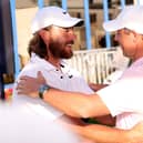 Northern Ireland's Rory McIlroy (right) and Tommy Fleetwood hug after the third round of the Dubai Invitational. (Photo by Warren Little/Getty Images)