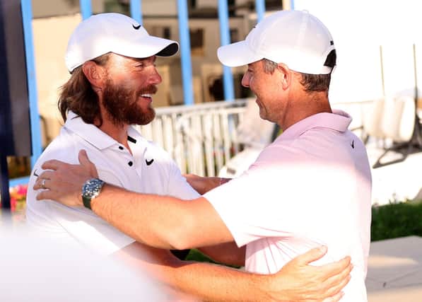 Northern Ireland's Rory McIlroy (right) and Tommy Fleetwood hug after the third round of the Dubai Invitational. (Photo by Warren Little/Getty Images)