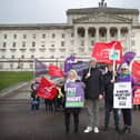 Patricia McKeown of Unison, Kieran Ellison and Thomas McMichael of Unite and Kim Hall of Unison as public sector workers protest outside Stormont on an historic day as inside the Northern Ireland Government returns after a two year gap.