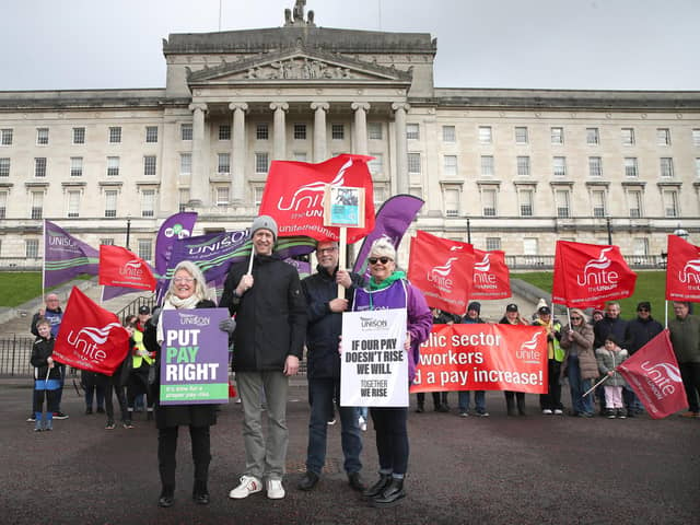 Patricia McKeown of Unison, Kieran Ellison and Thomas McMichael of Unite and Kim Hall of Unison as public sector workers protest outside Stormont on an historic day as inside the Northern Ireland Government returns after a two year gap.