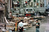 An RUC officer looks at the damage caused by a bomb explosion in Market Street, Omagh, on August 15, 1998. Photo: Paul McErlane/PA Archive