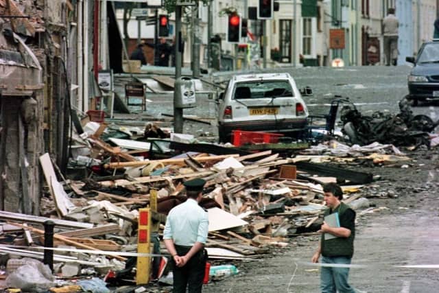An RUC officer looks at the damage caused by a bomb explosion in Market Street, Omagh, on August 15, 1998. Photo: Paul McErlane/PA Archive