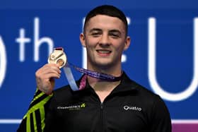 Rhys McClenaghan poses on the podium of the men's pommel horse at the 2023 Artistic Gymnastics European Championships