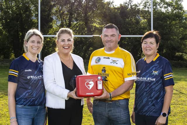 Belfast City Airport donates life-saving equipment in memory of ‘wee’ Maggie Black who sadly lost her life at the age of five to undiagnosed and extremely rare Addison’s Disease. Sheenagh Black, Maggie’s mother (left) was on hand to receive the honour in her daughter’s memory from  Belfast City Airport, Michelle Hatfield (second left), alongside St John’s Camogie Club chairman, Eamon McFadden (second right) and Margaret Quinn, Maggie’s aunt and longstanding St John’s Camogie Club member.