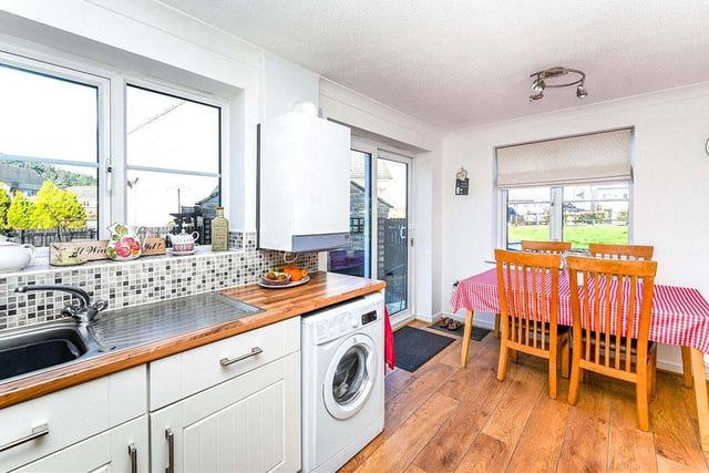 Here is the dining area of the kitchen. As you can see, there is plenty of room for a table and chairs. There is also space and plumbing for a washing machine, while uPVC double-glazed sliding doors lead out into the property's rear enclosed garden.