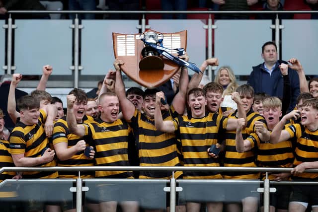 RBAI captain Jacob Boyd lifts the Danske Bank Schools Cup following victory over defeating Campbell College in 2023