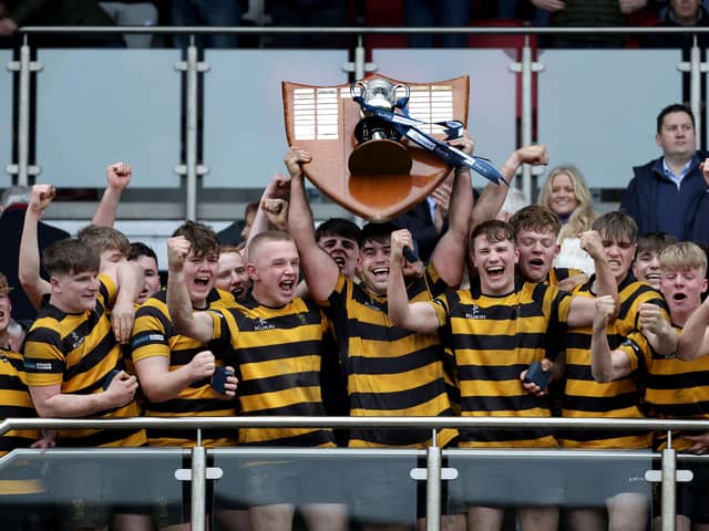 RBAI captain Jacob Boyd lifts the Danske Bank Schools Cup following victory over defeating Campbell College in 2023