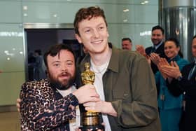 Actor James Martin (left) and co-director Ross White celebrate as some of the Oscar-wining team behind short film An Irish Goodbye arrive back at Dublin Airport