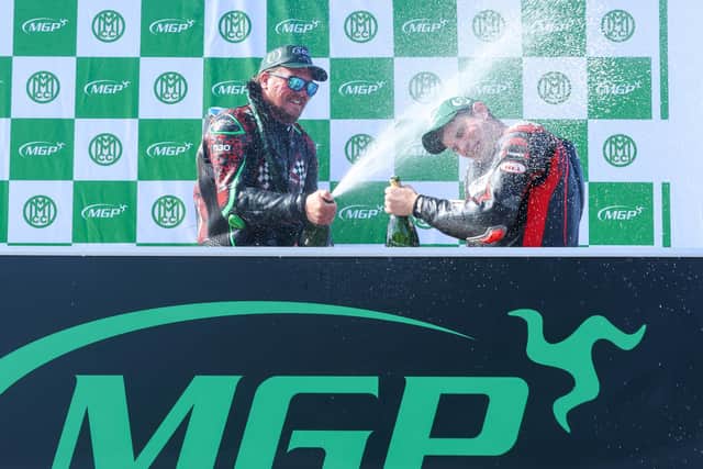 Limavady's Graham McAleese (right) celebrates his third place in the Senior Manx Grand Prix with race winner Johnny Stewart. (Photo by Callum Staley/Pacemaker Press)