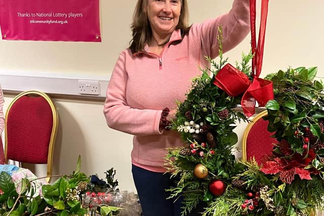 A member of The Diamond Community Development Association taking part in holly wreath workshops in the run up to Christmas. The group has received a £9,350 grant from The National Lottery Community Fund to run activities, including reminiscence sessions and festive events, to improve the wellbeing of the local community.