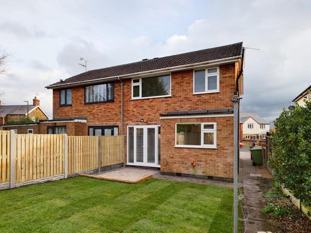 Stepping back outside, this is the view from the rear, showing the patio doors in the main lounge/diner and also the lawned garden.