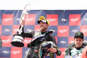 FHO Racing BMW rider Peter Hickman celebrates with the Senior TT trophy in 2023