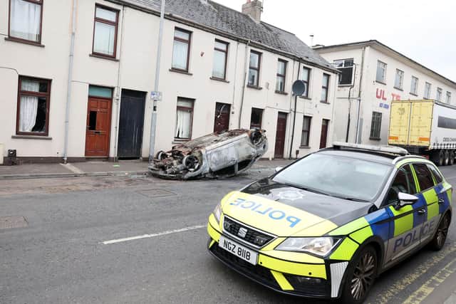 PSNI sits outside homes attacked by rioters in racially motivated attacks in June 2025