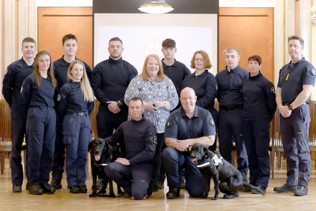 Rescue workers Ryan Gray (left) with his dog Max, and Kyle Murray with his dog Delta, and others from the charity, K9 Search and Rescue NI, meet Alliance party leader Naomi Long at Stormont, in Belfast.