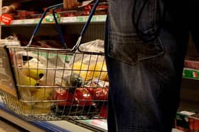 A person shopping in a supermarket. Photo: Julien Behal/PA Wire