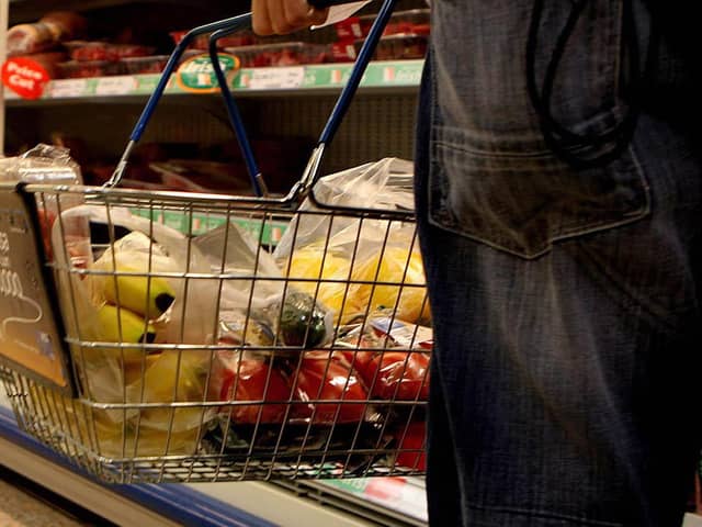 A person shopping in a supermarket. Photo: Julien Behal/PA Wire