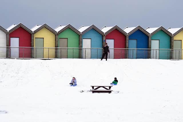 People ride sledges besides the beach huts at Blyth in Northumberland on Sunday, as temperatures dropped to around minus 11C in parts of the UK over the weekend. 
Photo: Owen Humphreys/PA Wire