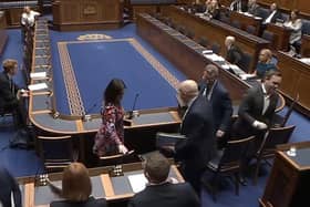 Alliance MLAs walk out of the chamber during a confidence debate in their farming minister Andrew Muir.