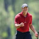 Tiger Woods acknowledges the crowd while walking to the 18th green during the final round of the 2024 Masters Ttournament at Augusta National Golf Club