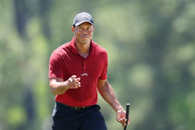Tiger Woods acknowledges the crowd while walking to the 18th green during the final round of the 2024 Masters Ttournament at Augusta National Golf Club