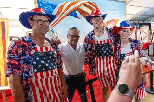 In Washington, artist Scott LoBaidom (second left) poses for a picture with fans at the Great American State Fair on the National Mall ahead of July 4 celebrations. Pic: AP Photo/Alex Brandon