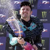 Michael Dunlop celebrates his 22nd Isle of Man TT victory after a dominant display in the opening Supersport race on Saturday