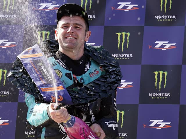 Michael Dunlop celebrates his 22nd Isle of Man TT victory after a dominant display in the opening Supersport race on Saturday