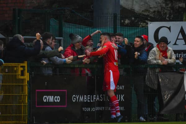 Joe Gormley celebrates with Cliftonville fans after his brace helped send Jim Magilton's side second in the race for Premiership glory. PIC: Andrew McCarroll/ Pacemaker Press