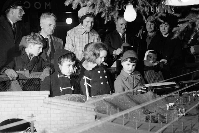 Children watch a model railway, part of Princes Street Station's Christmas decorations, in 1962.