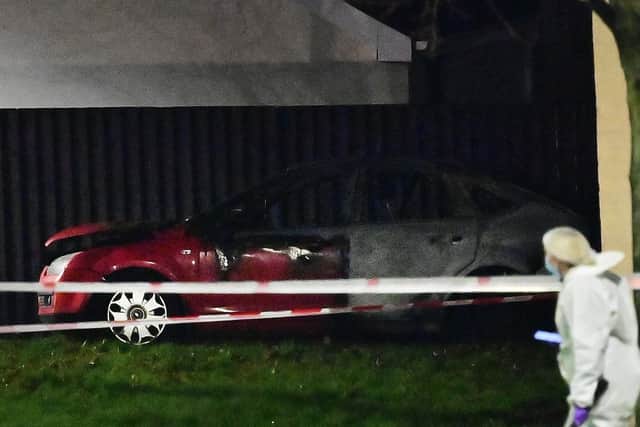 A burnt out car at the scene of a murder investigation in Lurgan. Police said they were investigating a sudden death on Edward street in the town on Sunday morning.
Pic Colm Lenaghan/Pacemaker