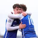 Paul McGovern celebrates with Peter Campbell after scoring last season. (Photo by Alan Weir/Pacemaker Press)