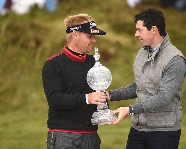 Soren Kjeldsen of Denmark receives the 2015 Irish Open trophy from Rory McIlroy at Royal County Down Golf Club. PIC: Ross Kinnaird/Getty Images