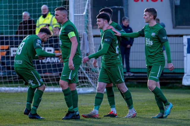 Jordan Jenkins celebrates with his teammates after scoring Dundela's fourth goal in their victory over Ards. PIC: Sarah Harkness/Pacemaker Press