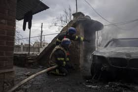 Rescue workers take cover after new explosions next to them as they try to put out a fire in a house which was shelled by Russian forces at the residential neighbourhood in Kostiantynivka, Ukraine.