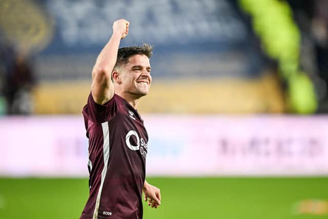 Rangers have confirmed the signing of former Hearts midfielder Cammy Devlin