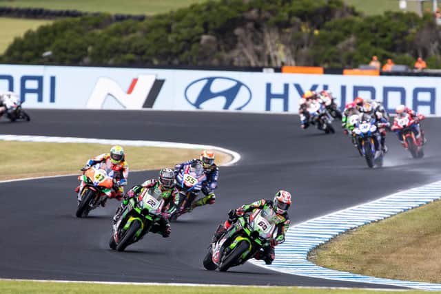 Jonathan Rea leads his Kawasaki Racing team-mate Alex Lowes in the wet at Phillip Island in Australia.