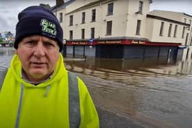 Brendan Downey, director of Friar Tucks restaurants, surveys the damage to one of his businesses - just behind him - caused by severe flooding in Newry