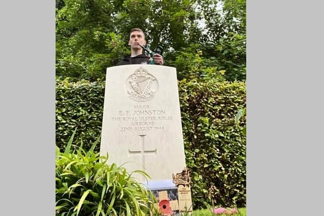 Former Pipe Major Angus Pollock at the grave of Old Campbellian Major Eric Johnston at Tourgeville CWGC