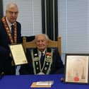Sir Knight Hilbert Willis receives his certificate marking his 100th birthday and 80 years of service from Sovereign Grand Master Rev William Anderson