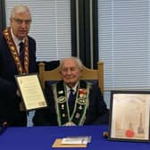 Sir Knight Hilbert Willis receives his certificate marking his 100th birthday and 80 years of service from Sovereign Grand Master Rev William Anderson