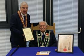 Sir Knight Hilbert Willis receives his certificate marking his 100th birthday and 80 years of service from Sovereign Grand Master Rev William Anderson