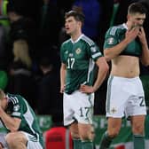 Northern Ireland players, from left, George Saville, Paddy McNair and captain Craig Cathcart following defeat to Finland