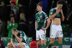 Northern Ireland players, from left, George Saville, Paddy McNair and captain Craig Cathcart following defeat to Finland