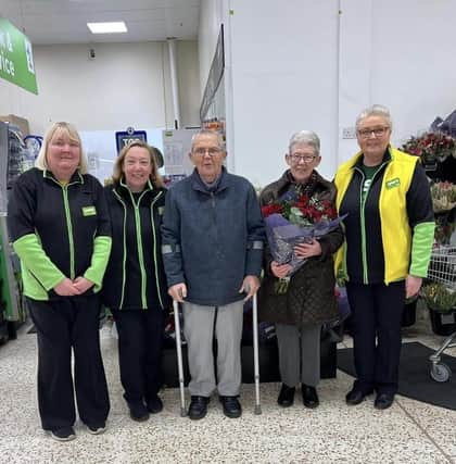 Jim and Mary Madine receive flowers from Asda Downpatrick staff to celebrate their 60th wedding anniversary