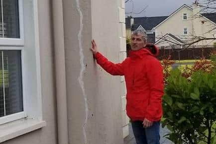Prof Paul Dunlop inspects the damage caused to his home by contaminated concrete.