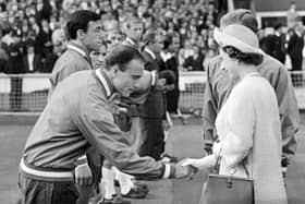 Queen Elizabeth II shakes hands with England defender George Cohen at Wembley Stadium during the 1966 World Cup