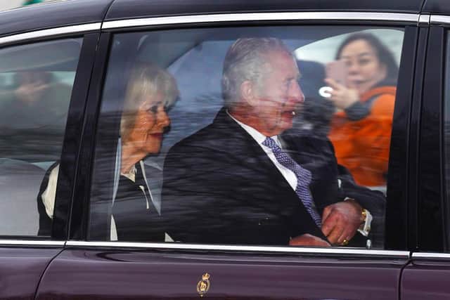 King Charles III and Queen Camilla on The Mall after leaving Clarence House in London on Tuesday. Charles and the Queen were driven away from their London residence to Buckingham Palace, before being flown by helicopter to Sandringham in Norfolk
