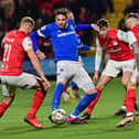 Linfield's Kyle Lafferty under pressure from Larne players in the Premiership scoreless draw